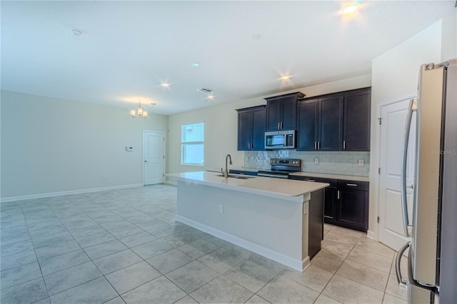 7524 Summerlake Groves St, Winter Garden, FL 34787 - kitchen featuring stainless steel appliances, light tile patterned floors, a chandelier, light countertops, and tasteful backsplash