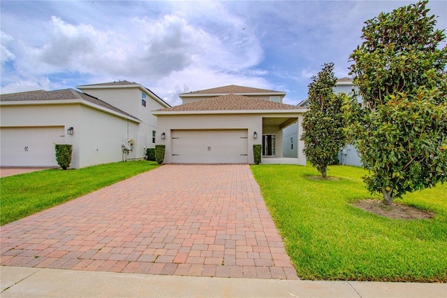 7524 Summerlake Groves St, Winter Garden, FL 34787 - view of front facade with stucco siding, a front lawn, decorative driveway, an attached garage, and a shingled roof