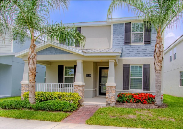 7524 Summerlake Groves St, Winter Garden, FL 34787 - view of front of property with stucco siding, a porch, and stone siding