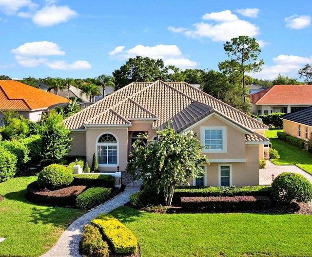 8974 Grey Hawk Pt, Orlando, FL 32836 - mediterranean / spanish-style home with stucco siding, a front yard, and a tile roof