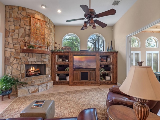 8974 Grey Hawk Pt, Orlando, FL 32836 - tiled living room featuring a stone fireplace, a ceiling fan, and recessed lighting