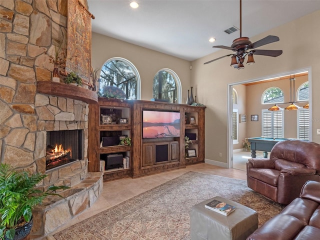 8974 Grey Hawk Pt, Orlando, FL 32836 - living area featuring billiards, a ceiling fan, a stone fireplace, recessed lighting, and a towering ceiling