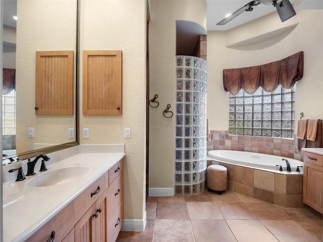 8974 Grey Hawk Pt, Orlando, FL 32836 - full bath with vanity, a bath, and tile patterned flooring