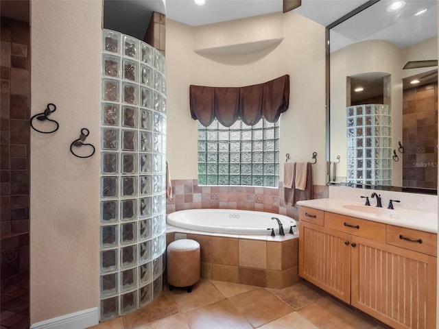 8974 Grey Hawk Pt, Orlando, FL 32836 - bathroom featuring walk in shower, tile patterned floors, vanity, and a garden tub