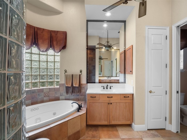 8974 Grey Hawk Pt, Orlando, FL 32836 - full bathroom featuring ceiling fan, a tub with jets, vanity, and tile patterned floors
