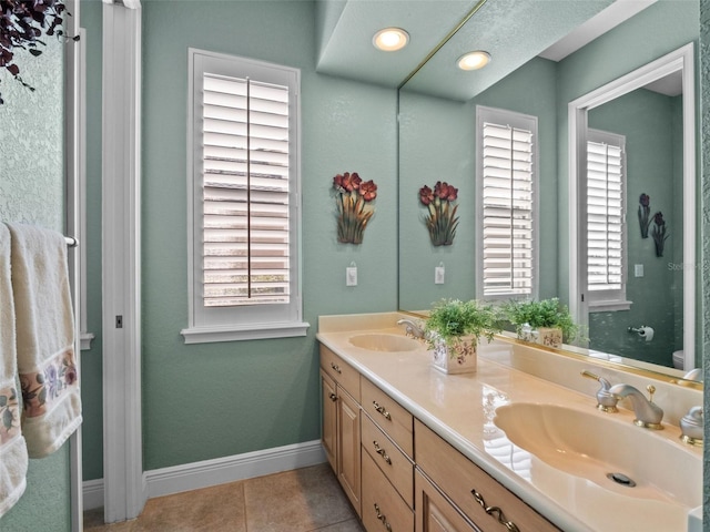 8974 Grey Hawk Pt, Orlando, FL 32836 - bathroom with double vanity, tile patterned flooring, and recessed lighting