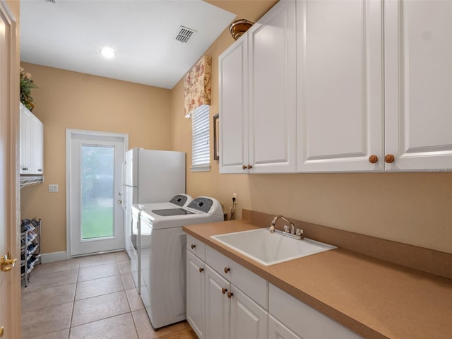 8974 Grey Hawk Pt, Orlando, FL 32836 - laundry area with washer and clothes dryer, cabinet space, light tile patterned floors, and recessed lighting