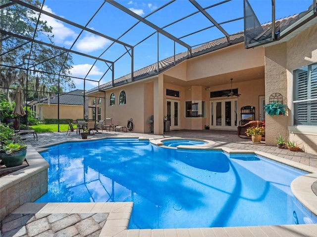 8974 Grey Hawk Pt, Orlando, FL 32836 - view of pool with french doors, a patio area, a pool with connected hot tub, a ceiling fan, and a lanai