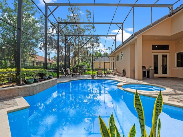 8974 Grey Hawk Pt, Orlando, FL 32836 - view of swimming pool with french doors, a patio, a pool with connected hot tub, and a lanai