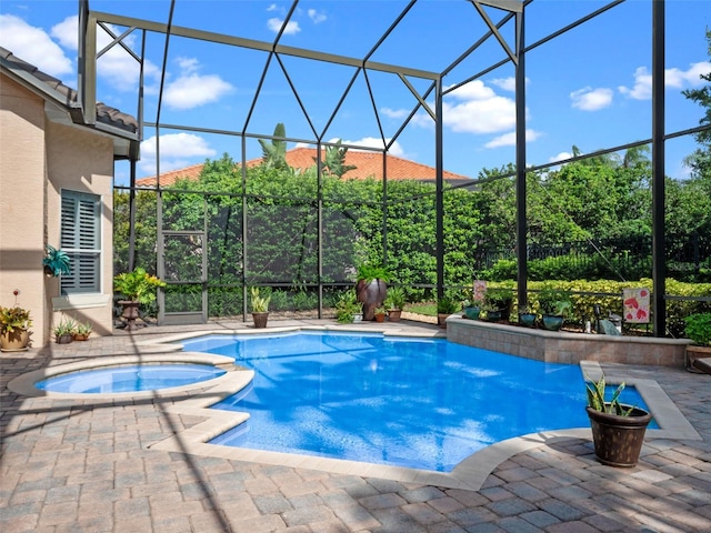 8974 Grey Hawk Pt, Orlando, FL 32836 - view of pool with glass enclosure, a pool with connected hot tub, and a patio area