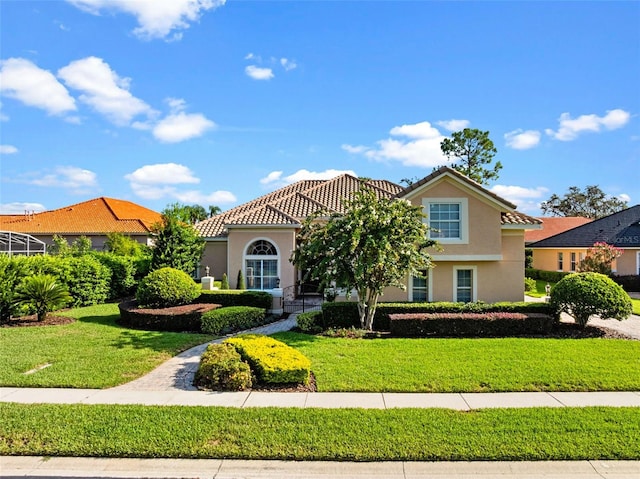 8974 Grey Hawk Pt, Orlando, FL 32836 - mediterranean / spanish-style home with a front yard, stucco siding, and a tiled roof