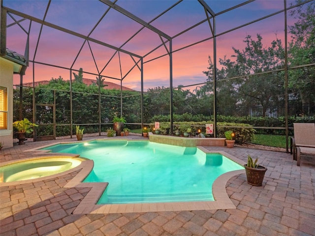 8974 Grey Hawk Pt, Orlando, FL 32836 - pool at dusk with a patio area, a lanai, and a pool with connected hot tub