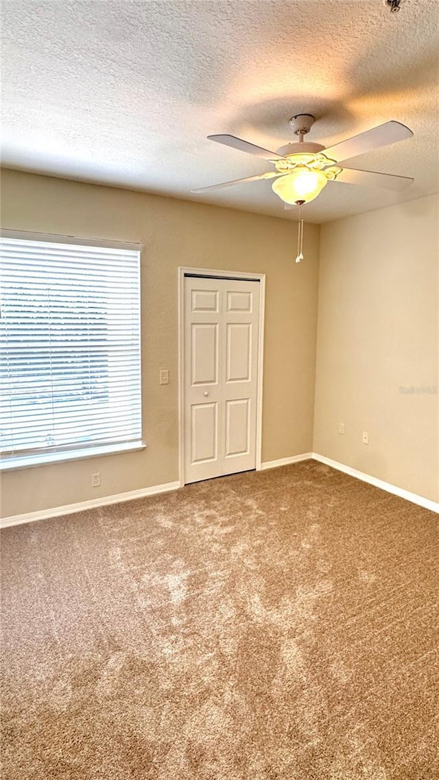 1375 Lake Shadow Cir Unit 11203, Maitland, FL 32751 - unfurnished bedroom featuring a textured ceiling, carpet, and a ceiling fan