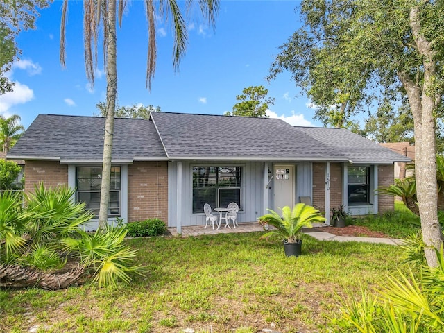 1510 Chatsworth Ave, Deltona, FL 32738 - view of front of property with brick siding, a shingled roof, and a front yard