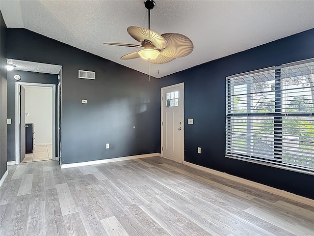 1510 Chatsworth Ave, Deltona, FL 32738 - unfurnished room with lofted ceiling, ceiling fan, a textured ceiling, and light wood finished floors