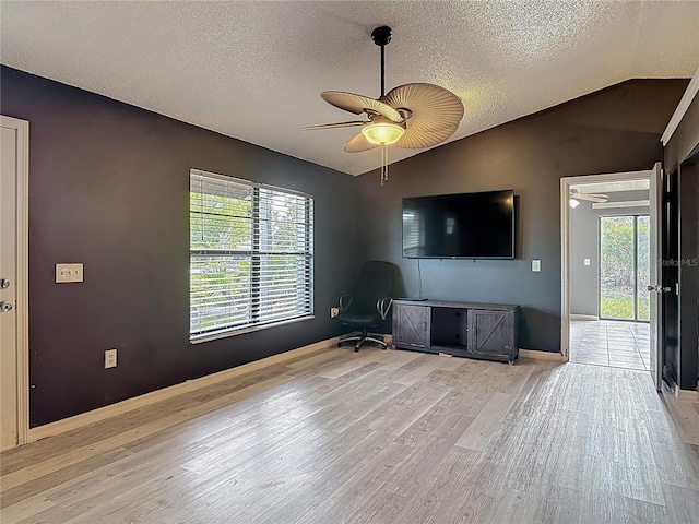 1510 Chatsworth Ave, Deltona, FL 32738 - unfurnished living room featuring wood finished floors, a textured ceiling, lofted ceiling, and ceiling fan