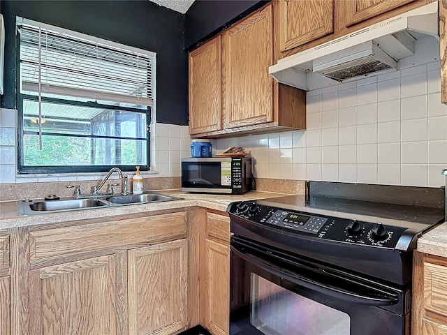 1510 Chatsworth Ave, Deltona, FL 32738 - kitchen with black / electric stove, stainless steel microwave, under cabinet range hood, light countertops, and decorative backsplash
