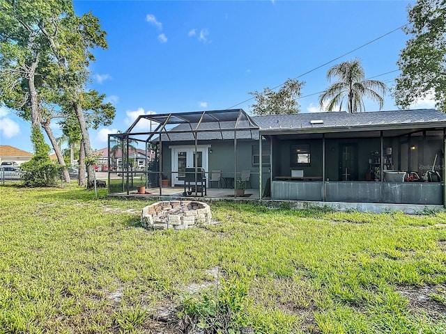 1510 Chatsworth Ave, Deltona, FL 32738 - back of property featuring an outdoor fire pit, a lawn, a patio, glass enclosure, and roof with shingles