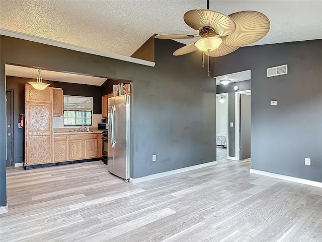 1510 Chatsworth Ave, Deltona, FL 32738 - kitchen featuring lofted ceiling, stainless steel refrigerator with ice dispenser, ceiling fan, light wood-style floors, and light countertops