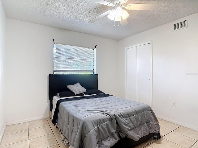 1510 Chatsworth Ave, Deltona, FL 32738 - bedroom with light tile patterned floors, a ceiling fan, a closet, and a textured ceiling