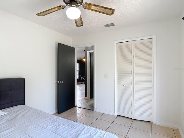 1510 Chatsworth Ave, Deltona, FL 32738 - unfurnished bedroom featuring light tile patterned floors, a closet, a textured ceiling, and ceiling fan