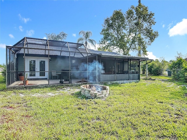 1510 Chatsworth Ave, Deltona, FL 32738 - back of house with a fire pit, french doors, a lawn, and a lanai