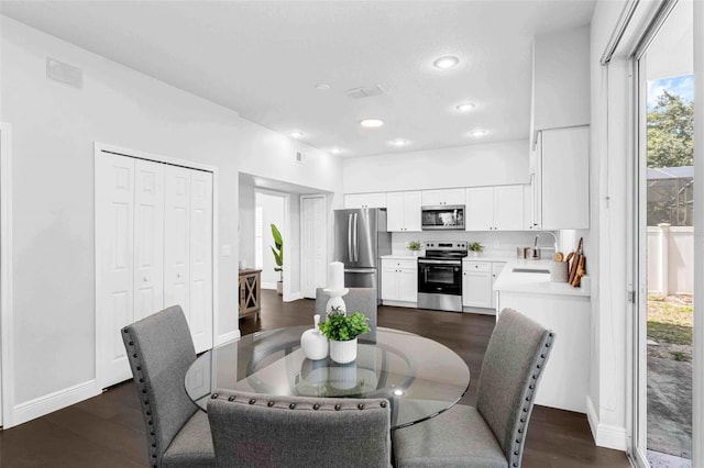 1121 Needlewood Loop, Oviedo, FL 32765 - dining space with healthy amount of natural light, dark wood finished floors, and recessed lighting