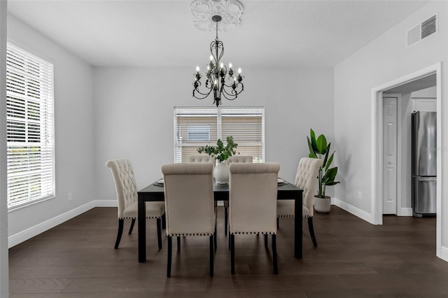 1121 Needlewood Loop, Oviedo, FL 32765 - dining space featuring a chandelier and dark wood-style flooring