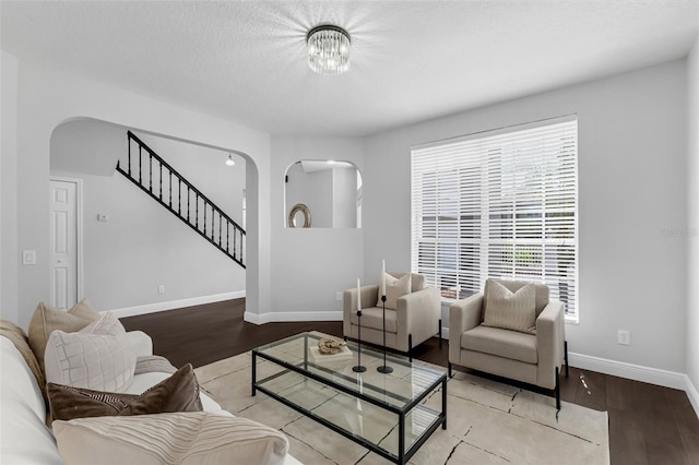 1121 Needlewood Loop, Oviedo, FL 32765 - living room with arched walkways, wood finished floors, and stairs