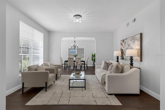 1121 Needlewood Loop, Oviedo, FL 32765 - living room featuring a chandelier, wood finished floors, and arched walkways