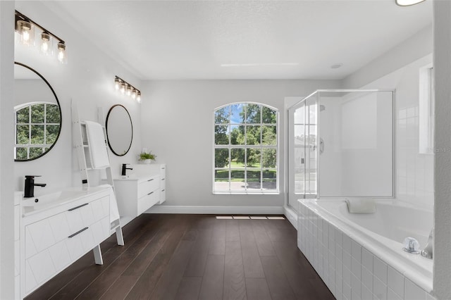 1121 Needlewood Loop, Oviedo, FL 32765 - full bath featuring plenty of natural light, a shower stall, two vanities, and tiled tub