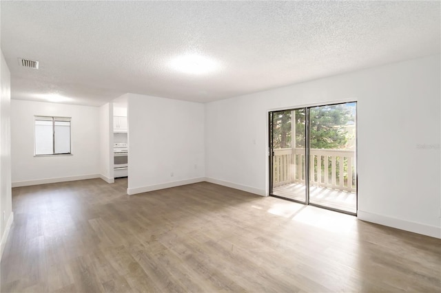 175 Springwood Cir Unit C, Longwood, FL 32750 - unfurnished room featuring a textured ceiling and light wood finished floors