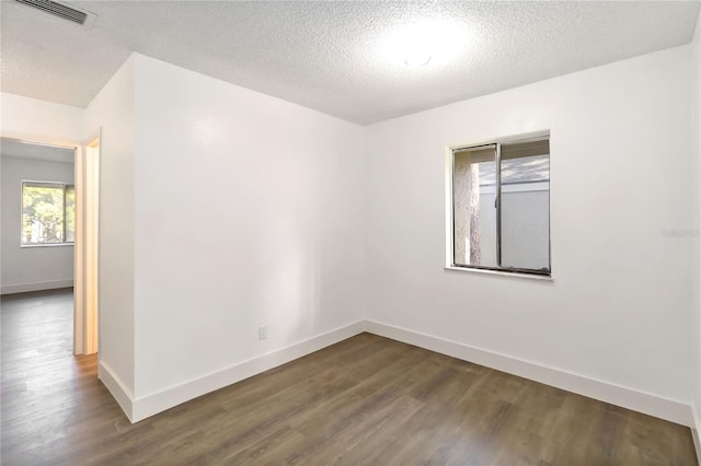 175 Springwood Cir Unit C, Longwood, FL 32750 - spare room with dark wood finished floors and a textured ceiling