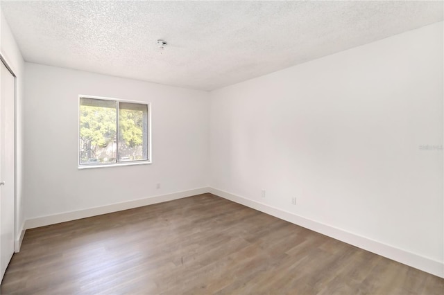 175 Springwood Cir Unit C, Longwood, FL 32750 - empty room featuring wood finished floors and a textured ceiling