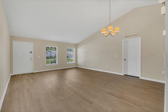 1617 Fairlight St NW, Palm Bay, FL 32907 - unfurnished living room featuring a chandelier, light wood-style flooring, and high vaulted ceiling