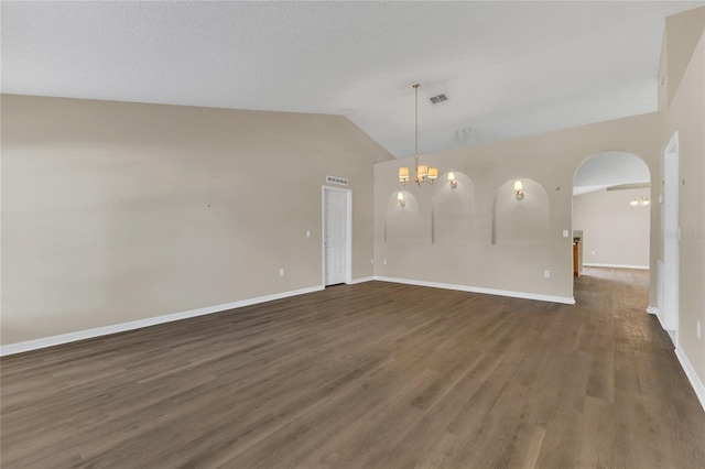 1617 Fairlight St NW, Palm Bay, FL 32907 - unfurnished room with lofted ceiling, wood finished floors, a chandelier, and arched walkways
