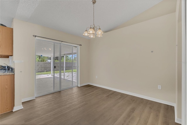 1617 Fairlight St NW, Palm Bay, FL 32907 - unfurnished dining area with wood finished floors, a chandelier, and lofted ceiling