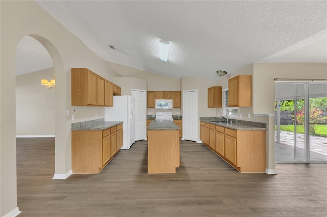 1617 Fairlight St NW, Palm Bay, FL 32907 - kitchen with white appliances, lofted ceiling, a center island, a textured ceiling, and dark wood-style flooring