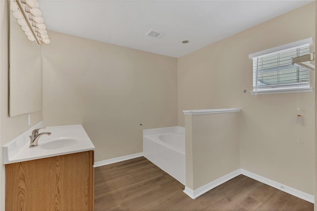 1617 Fairlight St NW, Palm Bay, FL 32907 - full bath featuring wood finished floors, a garden tub, and vanity