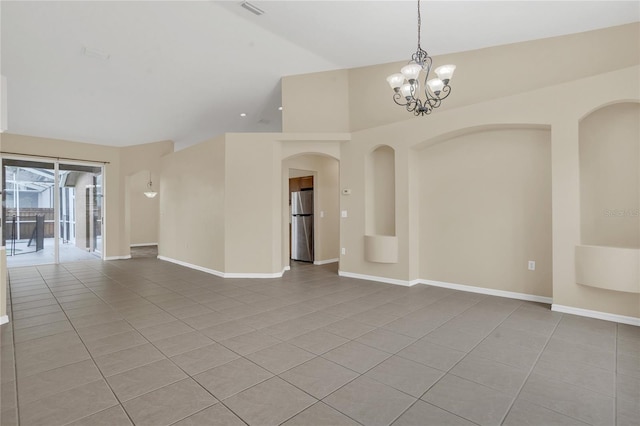 2408 Groveway Dr, Valrico, FL 33596 - empty room featuring light tile patterned flooring, a chandelier, arched walkways, and high vaulted ceiling