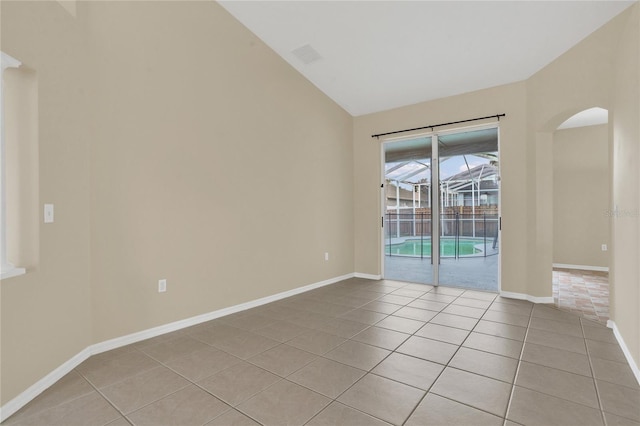 2408 Groveway Dr, Valrico, FL 33596 - empty room featuring light tile patterned flooring, lofted ceiling, and arched walkways
