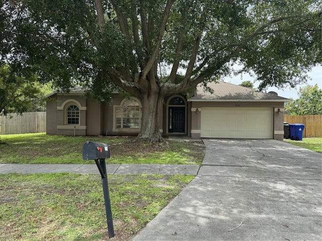 2116 New Victor Rd, Ocoee, FL 34761 - view of front of property with stucco siding, an attached garage, and driveway