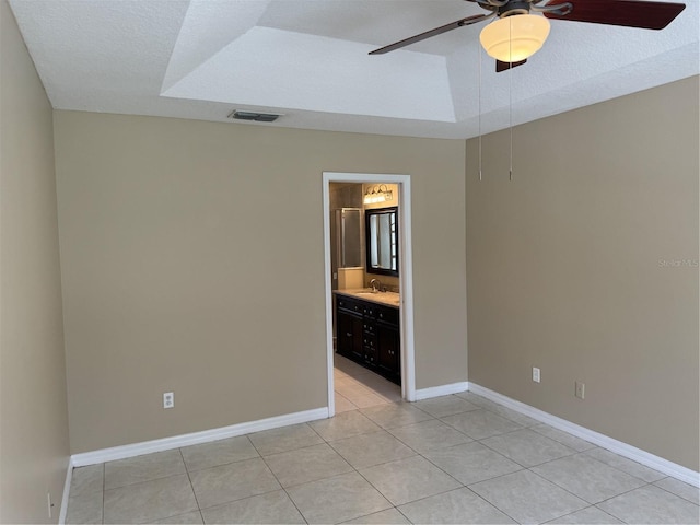 2116 New Victor Rd, Ocoee, FL 34761 - spare room with a raised ceiling, ceiling fan, and light tile patterned floors