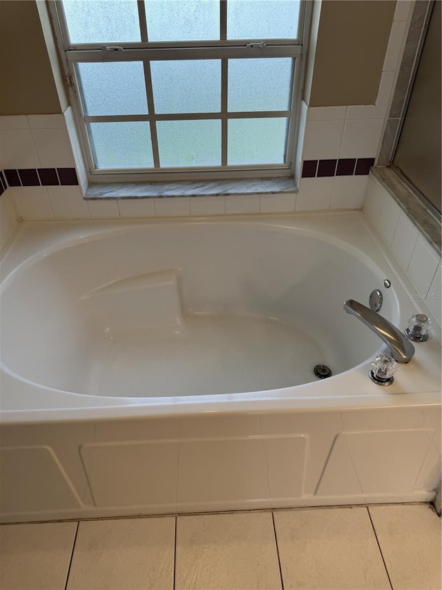 2116 New Victor Rd, Ocoee, FL 34761 - bathroom featuring a garden tub and tile patterned floors