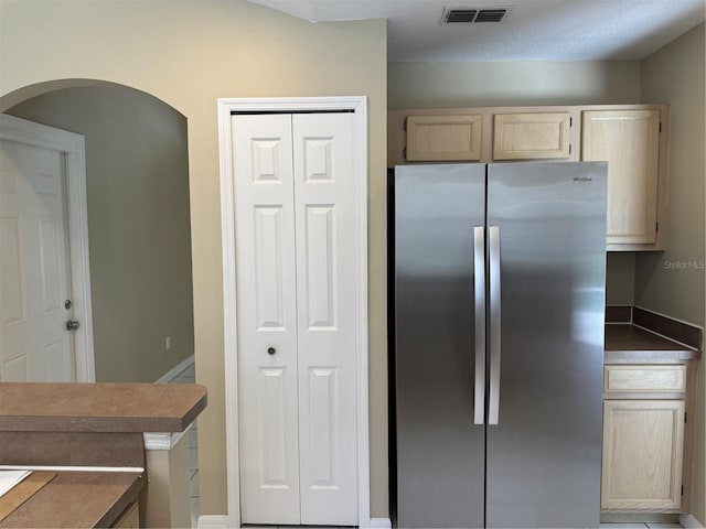 2116 New Victor Rd, Ocoee, FL 34761 - kitchen featuring freestanding refrigerator, arched walkways, and light brown cabinetry