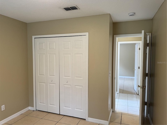 2116 New Victor Rd, Ocoee, FL 34761 - unfurnished bedroom featuring light tile patterned floors and a closet