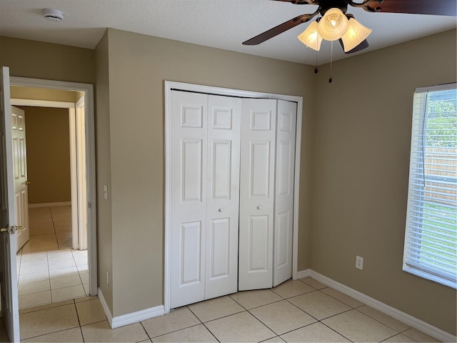 2116 New Victor Rd, Ocoee, FL 34761 - unfurnished bedroom featuring light tile patterned floors, a closet, and a ceiling fan