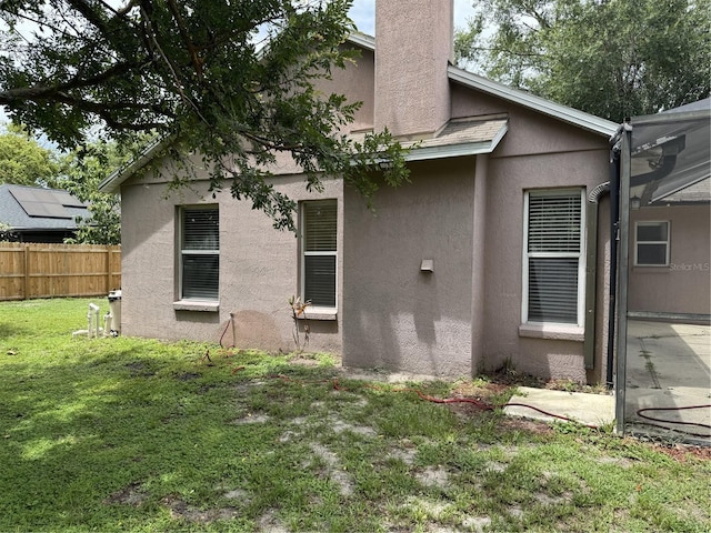 2116 New Victor Rd, Ocoee, FL 34761 - back of property featuring stucco siding, a lanai, a patio, and a chimney