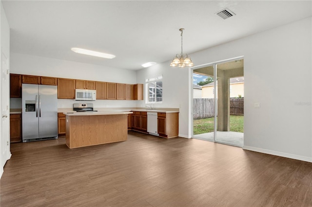 13510 Copper Belly Ct, Riverview, FL 33569 - kitchen with stainless steel appliances, light countertops, a chandelier, and dark wood-style floors