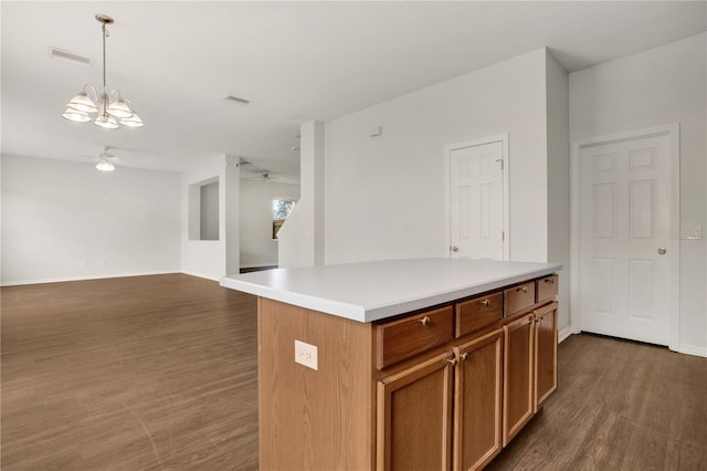 13510 Copper Belly Ct, Riverview, FL 33569 - kitchen featuring ceiling fan, dark wood finished floors, pendant lighting, light countertops, and brown cabinetry
